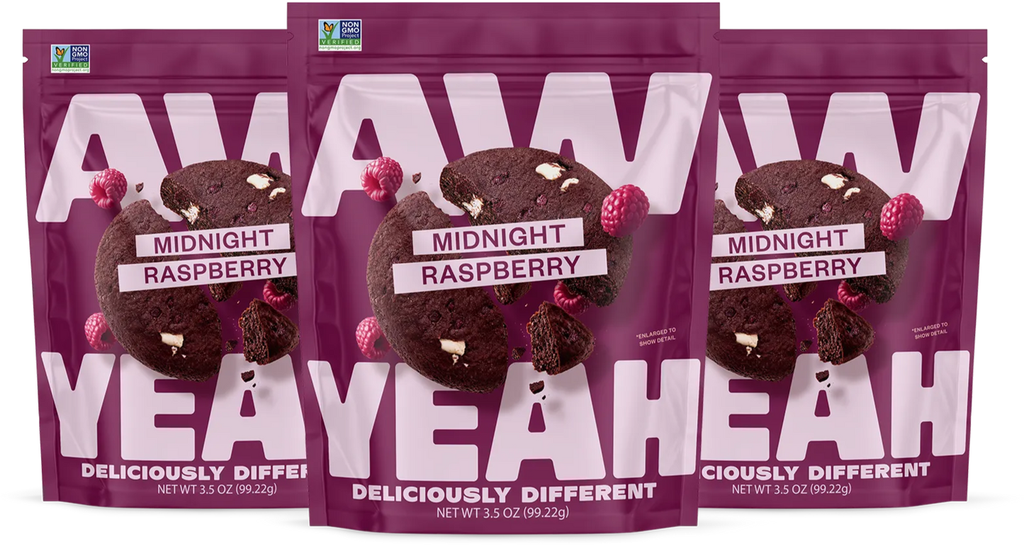 three packages gluten free non GMO dairy free cookies Purple package of AW Yeah Midnight Raspberry cookies
