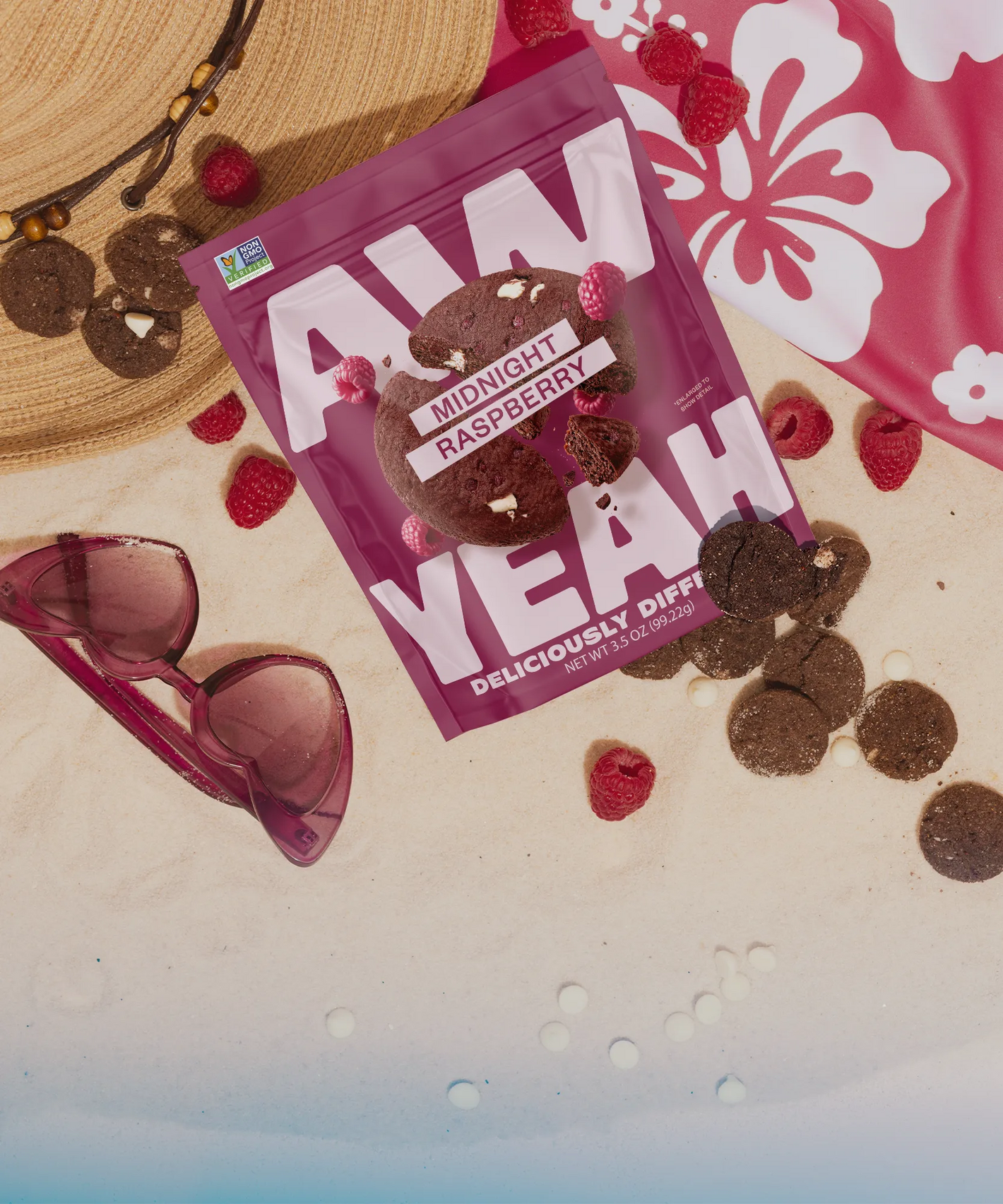 midnight chocolate raspberry gluten free non GMO dairy free cookies Bag of 'Aw Yeah' midnight raspberry cookies with sunglasses and raspberries on a beach setting